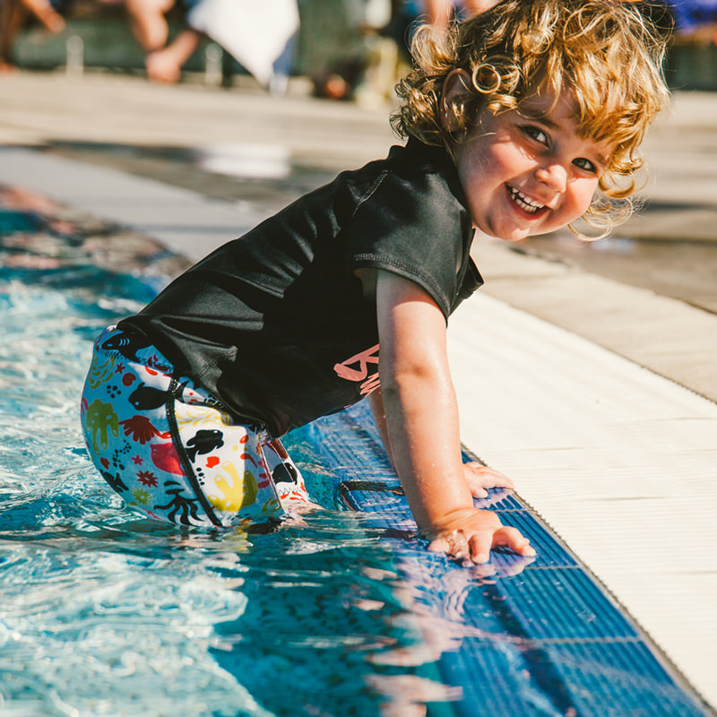 Conni containment swim shorts worn by the pool